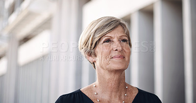 Buy stock photo Shot of a mature businesswoman walking through the city