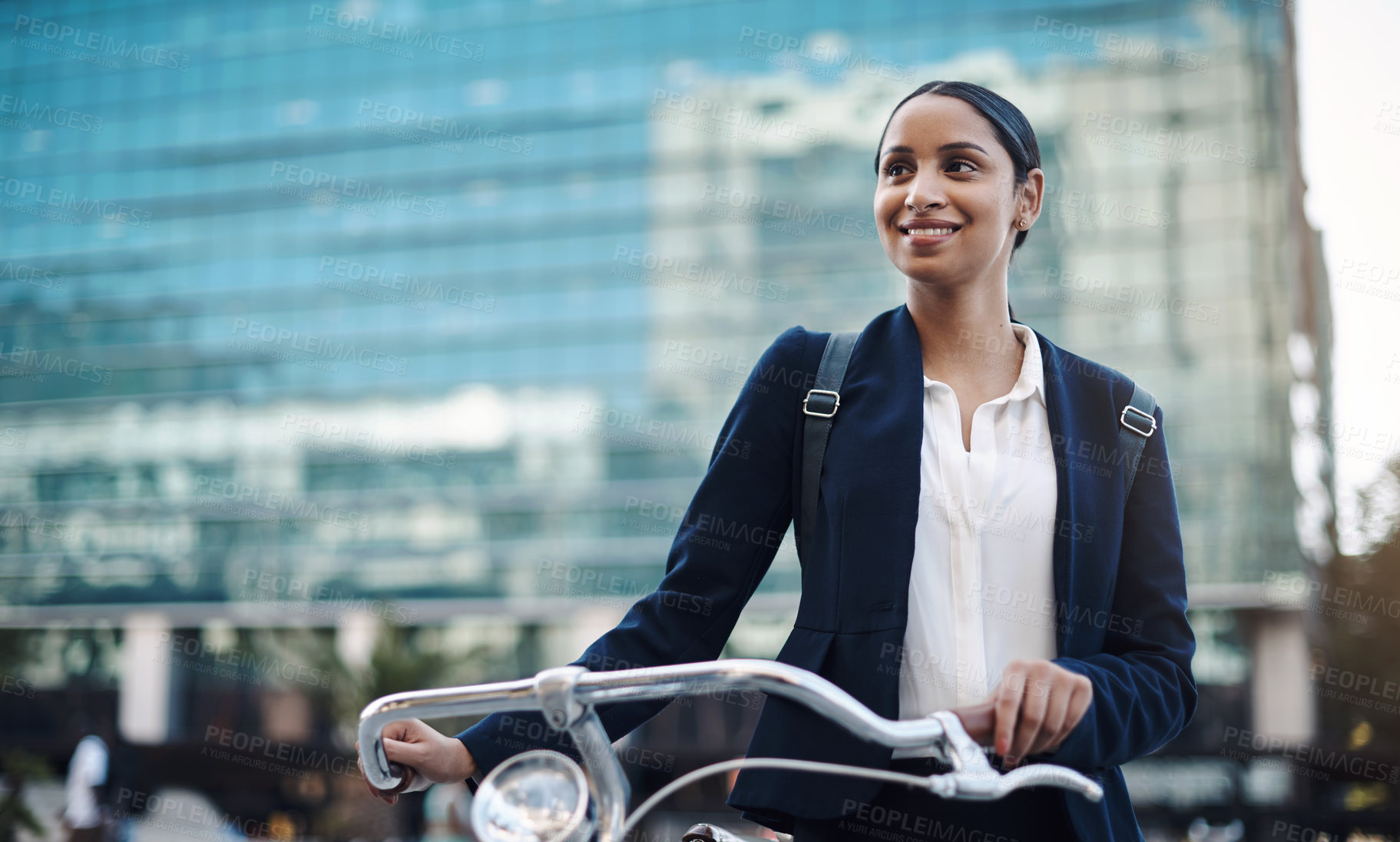 Buy stock photo Shot of a young businesswoman traveling with a bicycle through the city