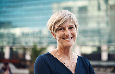 Buy stock photo Portrait of a confident mature businesswoman against a city background