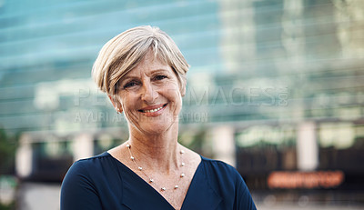 Buy stock photo Portrait of a confident mature businesswoman against a city background