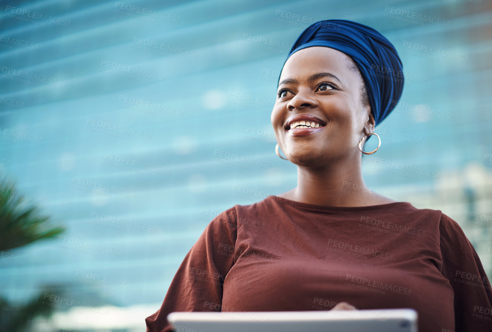 Buy stock photo Shot of a young businesswoman using a digital tablet against a city background