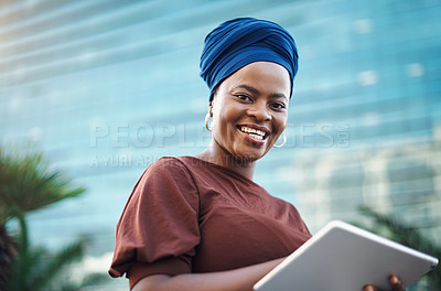 Buy stock photo Shot of a young businesswoman using a digital tablet against a city background
