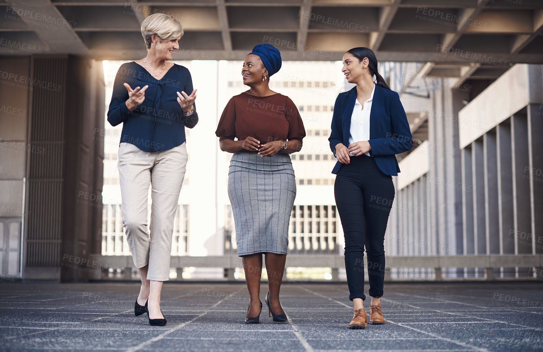 Buy stock photo Shot of a group of businesswomen having a discussion against a city background