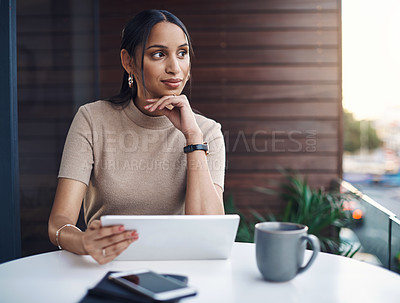 Buy stock photo Cropped shot of an attractive young businesswoman using her tablet while working in the office