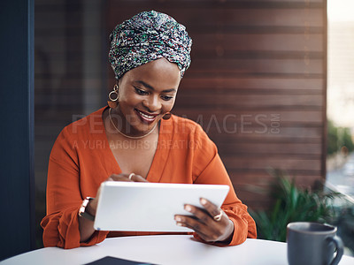 Buy stock photo Cropped shot of an attractive businesswoman working on her tablet in the office