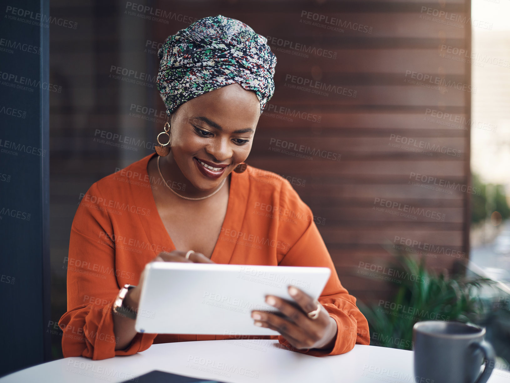 Buy stock photo Cropped shot of an attractive businesswoman working on her tablet in the office