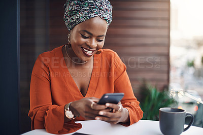 Buy stock photo Cropped shot of an attractive businesswoman sending a text while working in her office