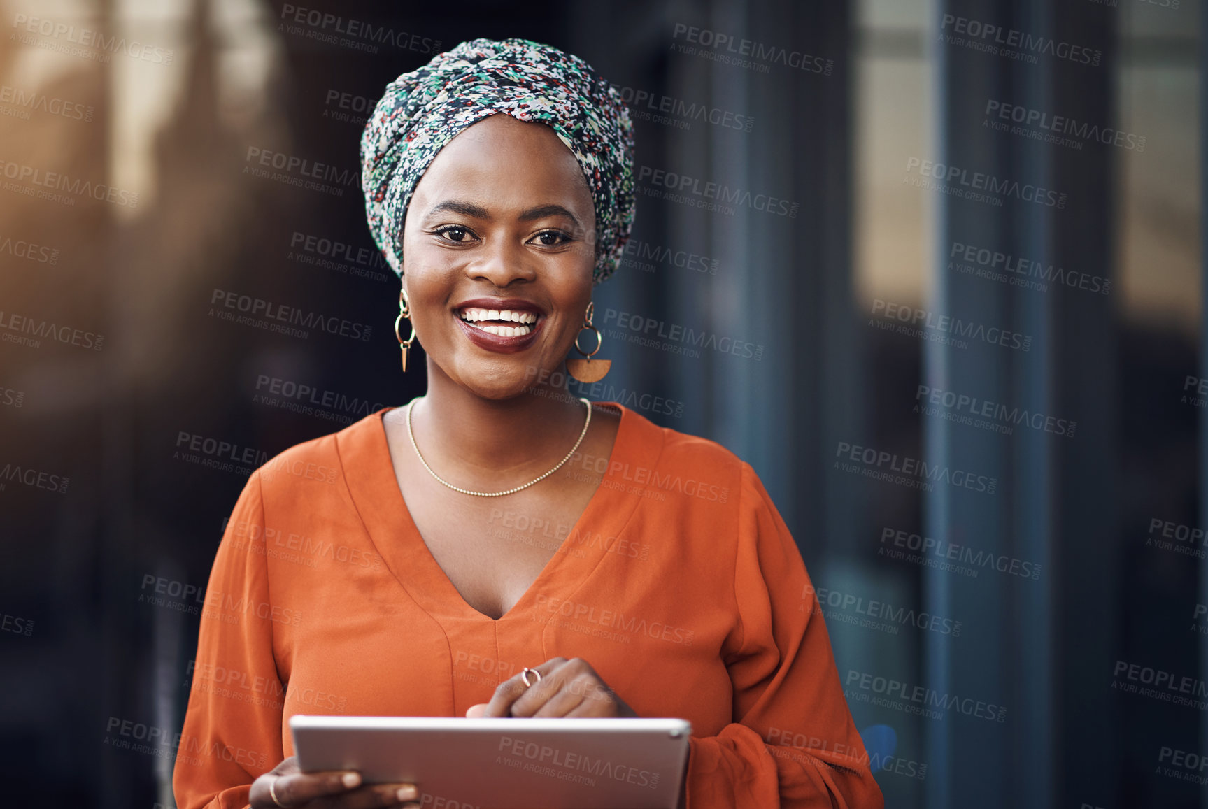 Buy stock photo Cropped portrait of an attractive businesswoman using her tablet while standing in the office