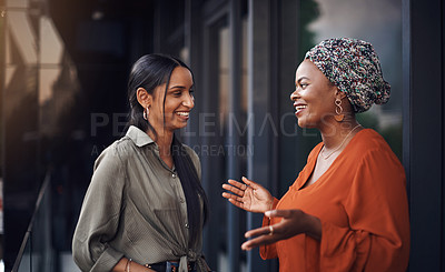 Buy stock photo Cropped shot of two attractive businesswomen discussing work in their office