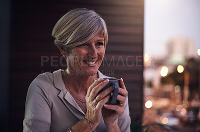 Buy stock photo Cropped shot of an attractive mature businesswoman enjoying a coffee while working in her office
