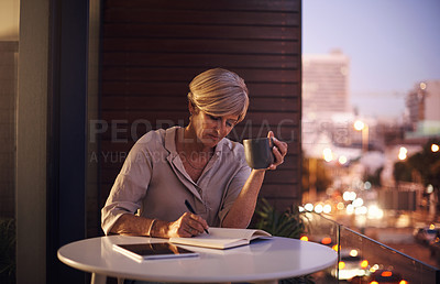 Buy stock photo Cropped shot of an attractive mature businesswoman taking notes while working late in her office