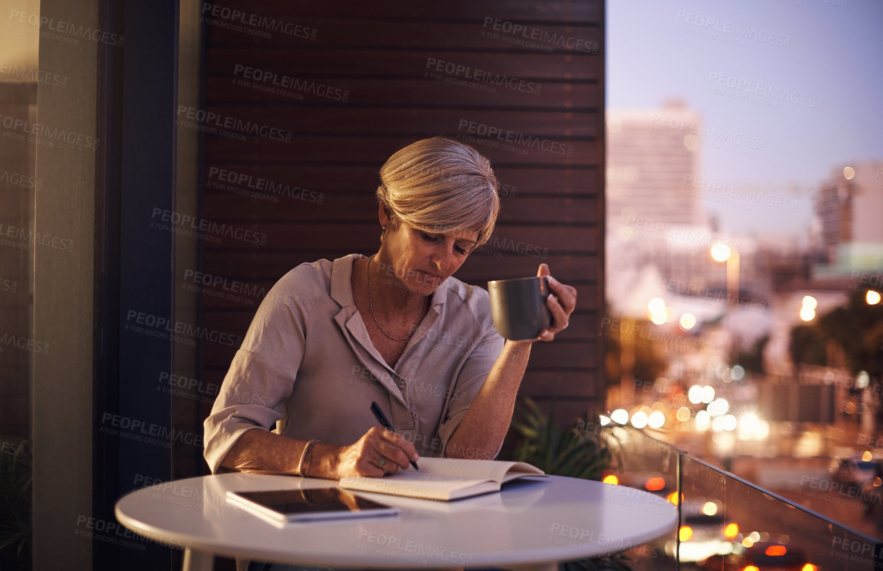 Buy stock photo Mature, woman and office at night with writing evening agenda, project schedule or notes with coffee. Professional, employer and notebook on company balcony in city with planning, timeline and ideas