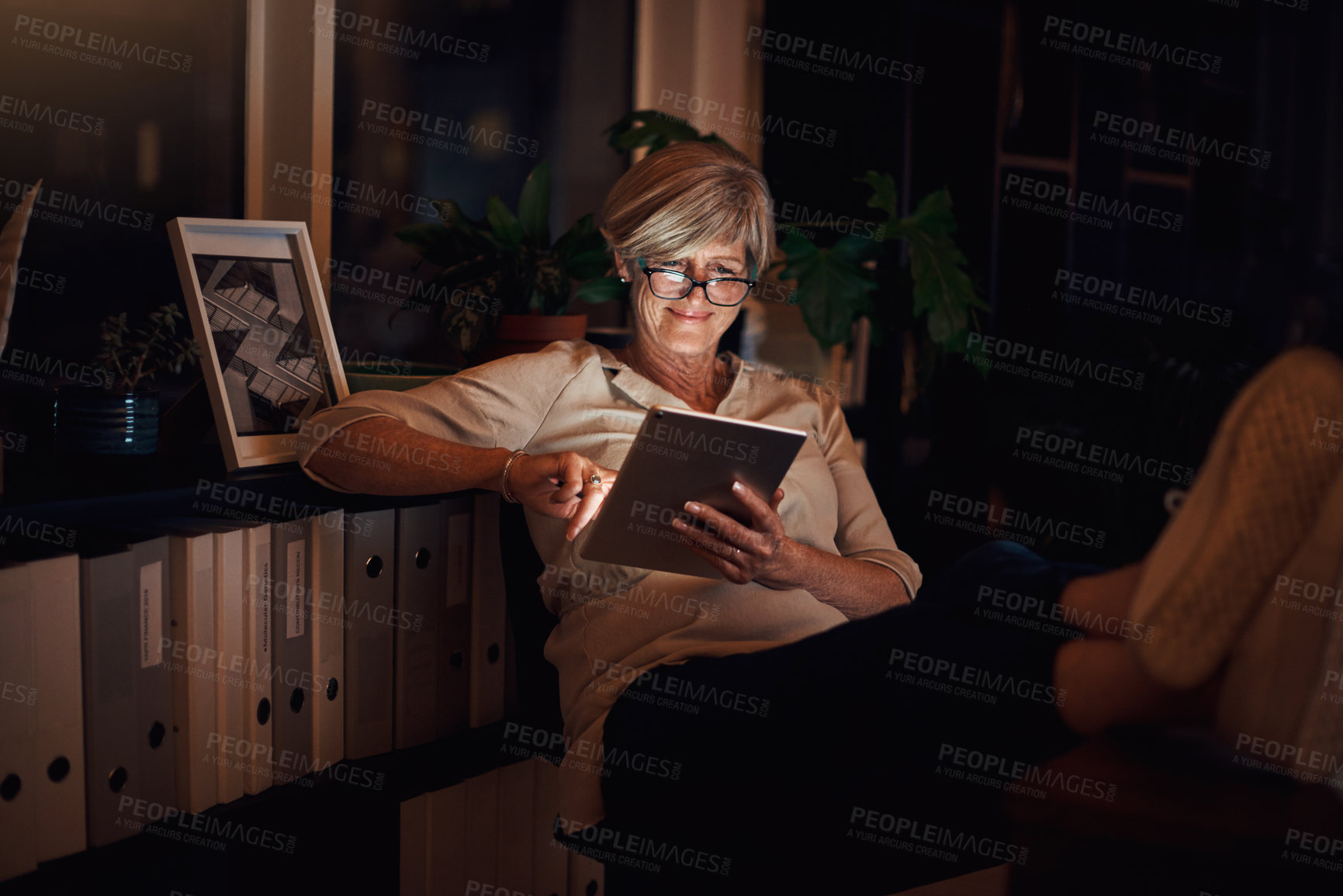 Buy stock photo Business, tablet and mature woman in office with relax for notification, web blog or comfortable with research. Reading, night and employee with glasses for information, email or online news article