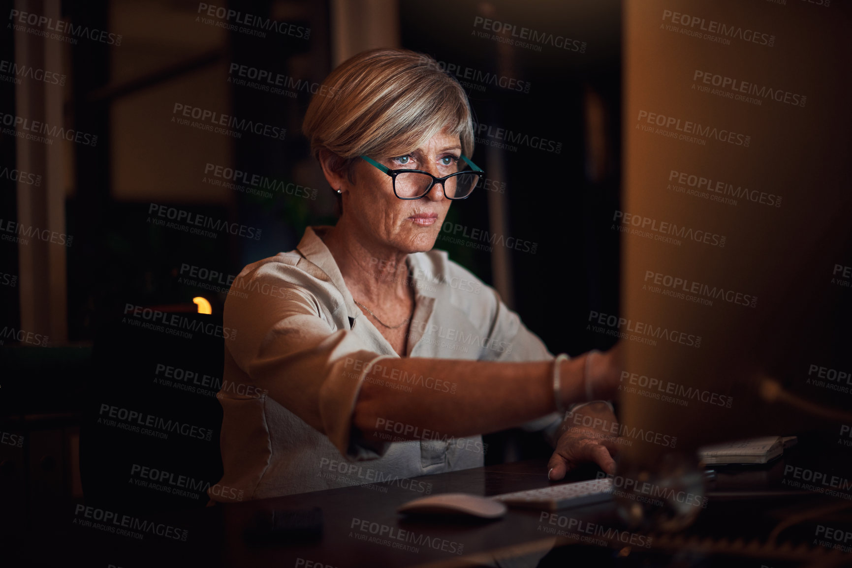 Buy stock photo Computer, reading and woman in office at night with email for risk management investment. Glasses, desktop and mature female actuary working on company revenue, profit or budget report deadline.