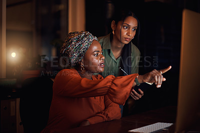 Buy stock photo Business women, working late and entrepreneur in office with pointing at computer. Female people, partner and teamwork for deadline, project planning or editing as online content creator at night