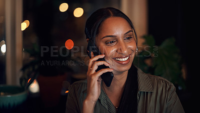 Buy stock photo Shot of a young businesswoman talking on a cellphone in an office at night