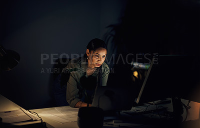 Buy stock photo Shot of a young businesswoman working on a laptop in an office at night
