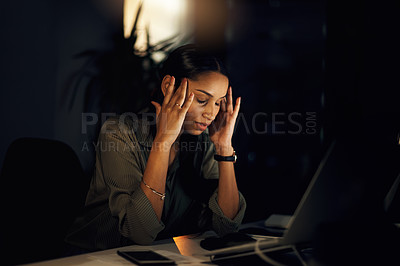 Buy stock photo Shot of a young businesswoman looking stressed out while working in an office at night