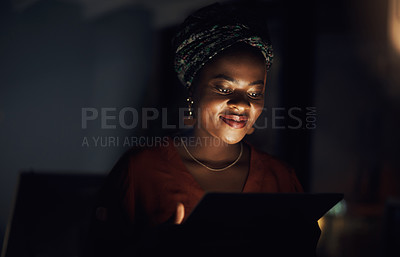 Buy stock photo Shot of a young businesswoman using a digital tablet in an office at night