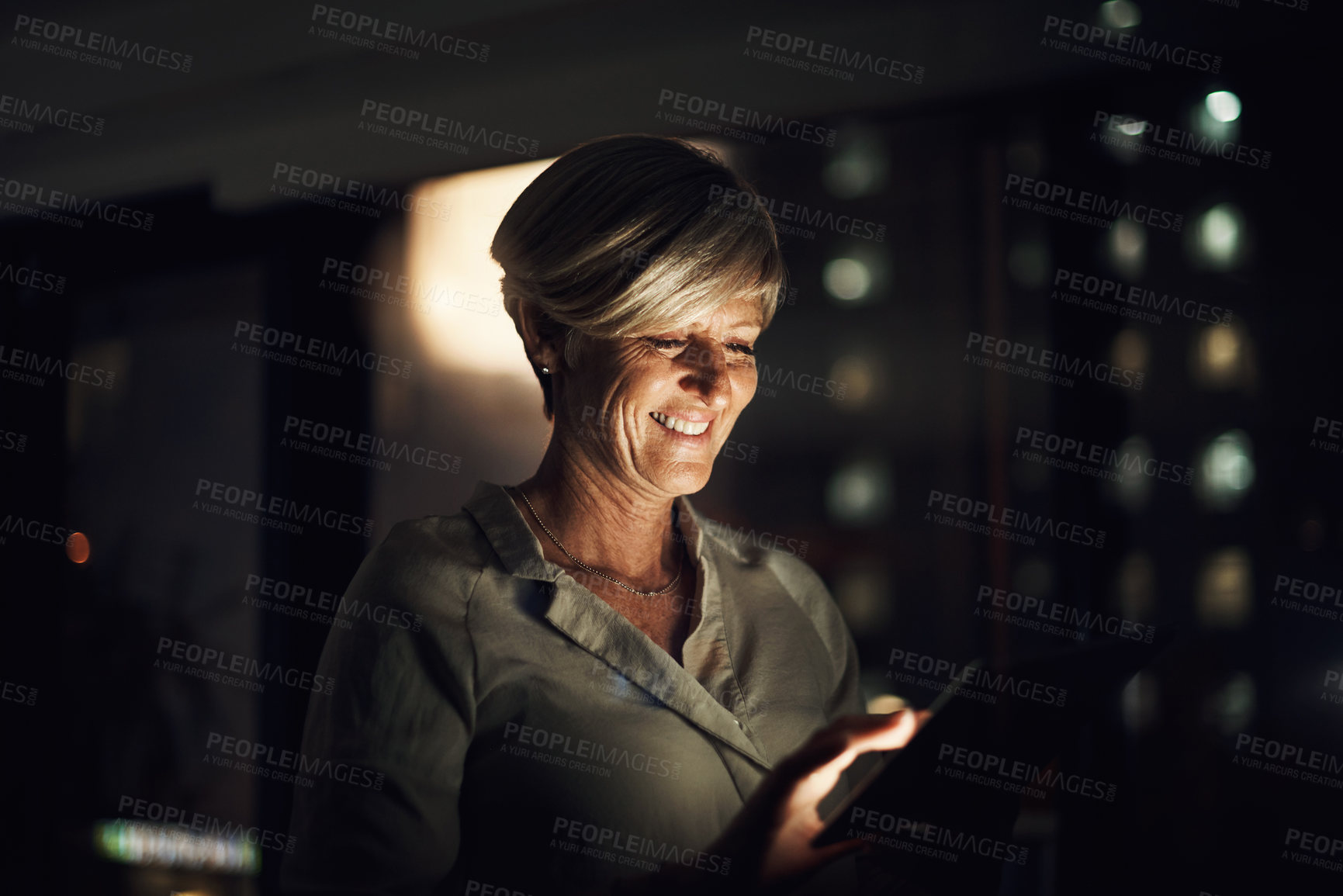 Buy stock photo Working late, mature woman and tablet in office for search, reading and business idea for problem solving. Night, web designer and digital in workplace for scroll results, solution or creative skills