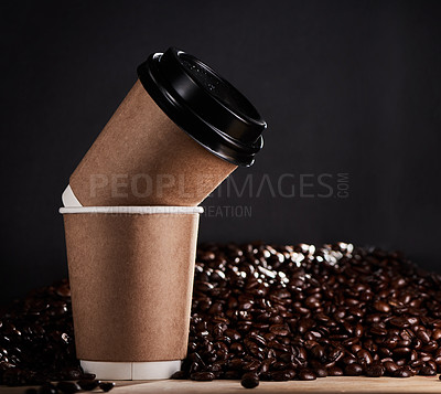 Buy stock photo Closeup shot of two paper cups with coffee beans in the background