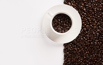 Buy stock photo Closeup shot of a cup filled with coffee beans against a half-and-half background