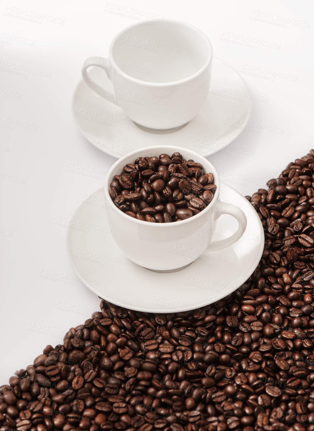 Buy stock photo Closeup shot of an empty cup and one filled with coffee beans against a half-and-half background