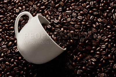 Buy stock photo Closeup shot of a cup on a pile of coffee beans