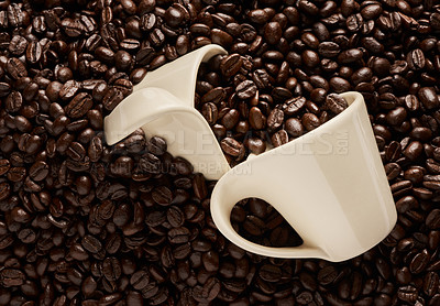 Buy stock photo Closeup shot of two cups on a pile of coffee beans