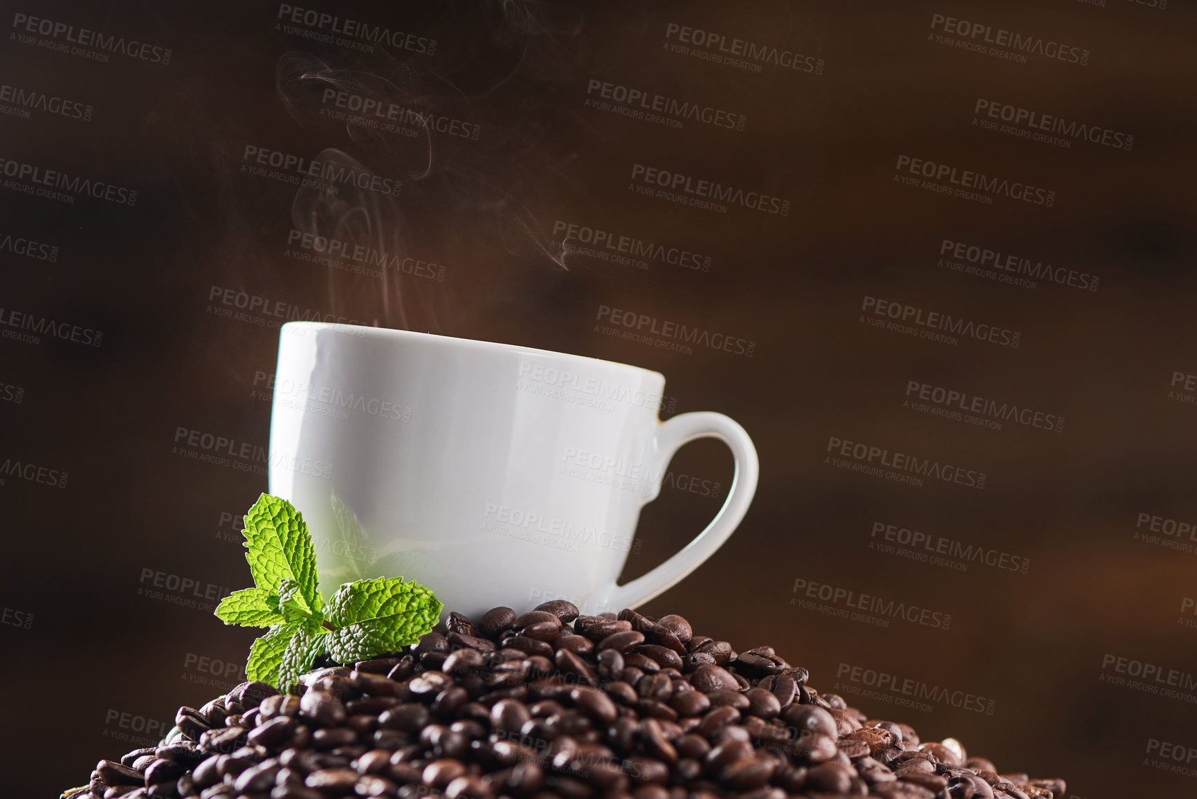 Buy stock photo Aroma, coffee beans and cup in studio with leaves, steam and sustainable business in cafe service. Flavor, organic roast or espresso drink with eco friendly resources for caffeine on brown background