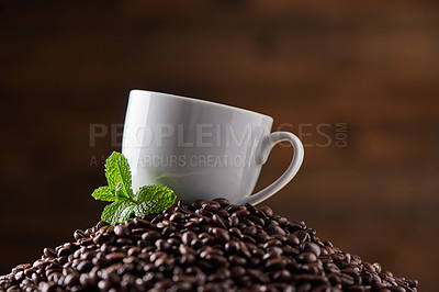 Buy stock photo Fresh, coffee beans and cup in studio with leaves, morning drink and sustainable business in cafe service. Flavor, organic roast or espresso with eco friendly caffeine resources on brown background