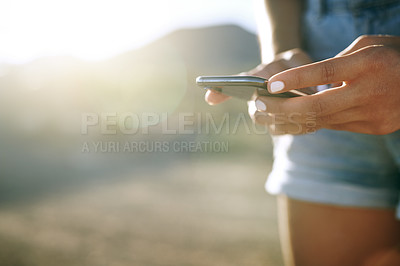 Buy stock photo Shot of an unrecognisable woman using a smartphone on a farm