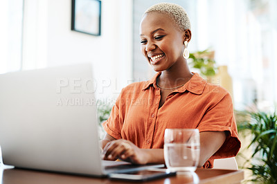 Buy stock photo Shot of a young businesswoman working on a laptop in an office