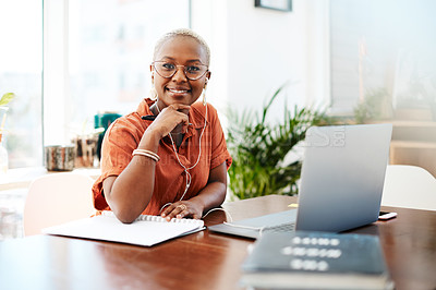 Buy stock photo Shot of a young businesswoman wearing earphones while working in an office