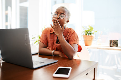 Buy stock photo Shot of a young businesswoman yawning while working in an office