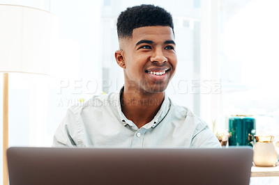 Buy stock photo Shot of a young businessman using a laptop in a modern office