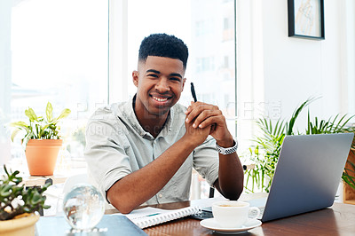 Buy stock photo Portrait of a confident young businessman working at his desk in a modern office