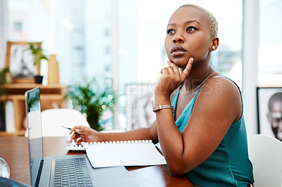Buy stock photo Shot of a young businesswoman working at her desk in a modern office