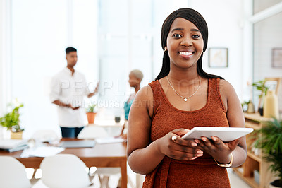 Buy stock photo Portrait of a young businesswoman using a digital tablet in a modern office