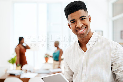 Buy stock photo Portrait of a young businessman using a digital tablet in a modern office