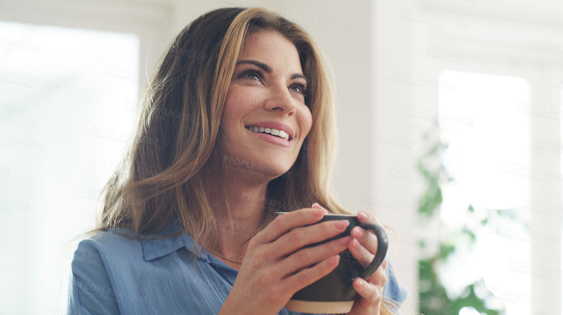 Buy stock photo Cropped shot of a beautiful woman enjoying a hot beverage at home