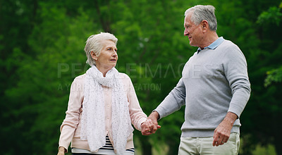 Buy stock photo Shot of a happy senior couple spending a romantic day in the park