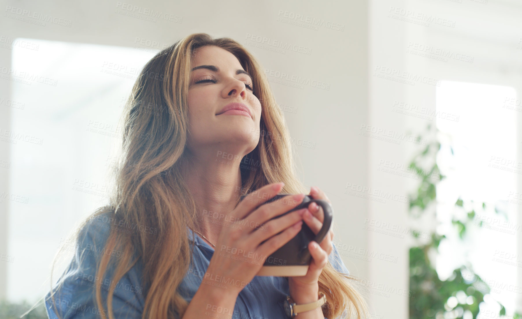 Buy stock photo Cropped shot of a beautiful woman enjoying a hot beverage at home
