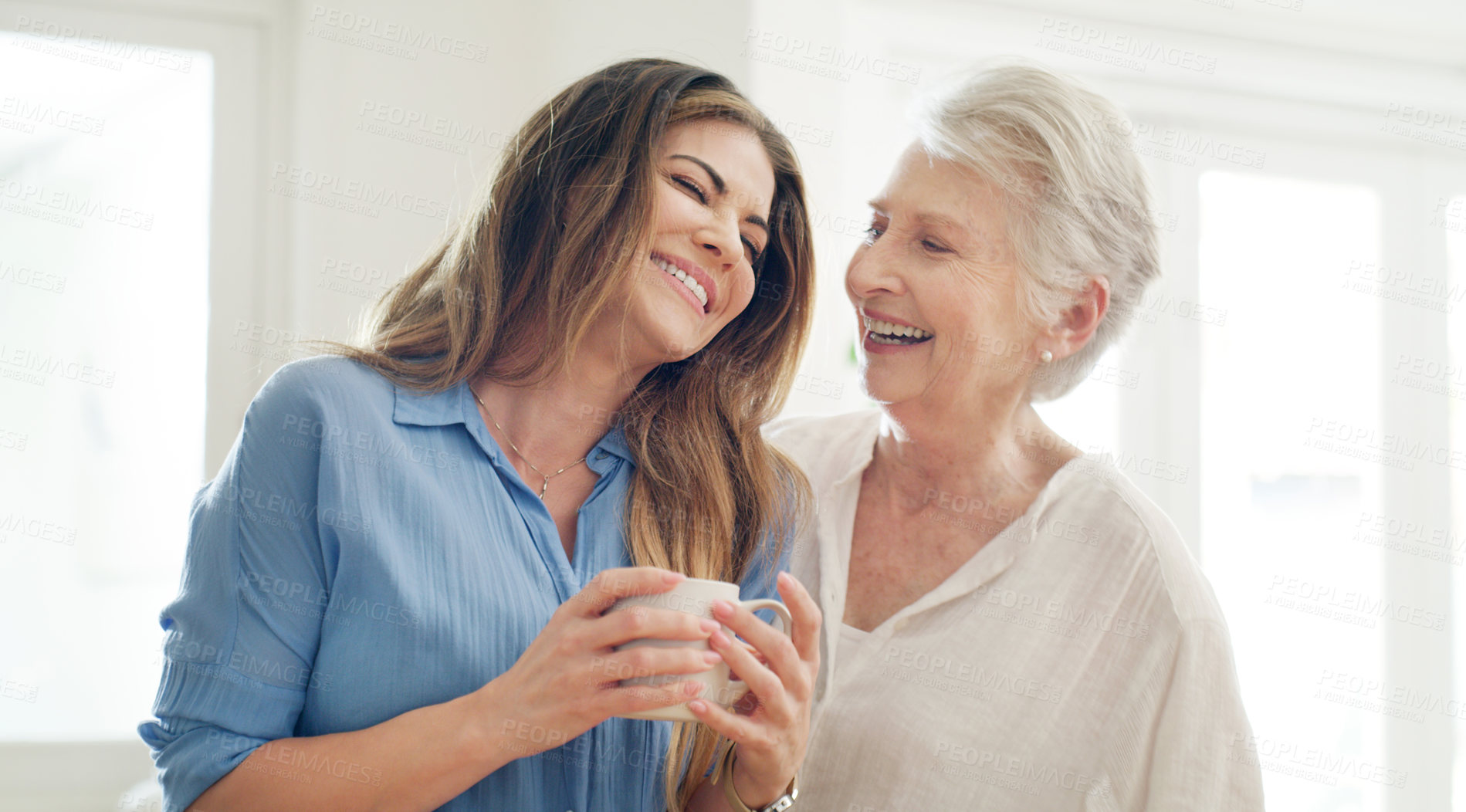 Buy stock photo Shot of a young woman and her senior mom spending quality time together at home