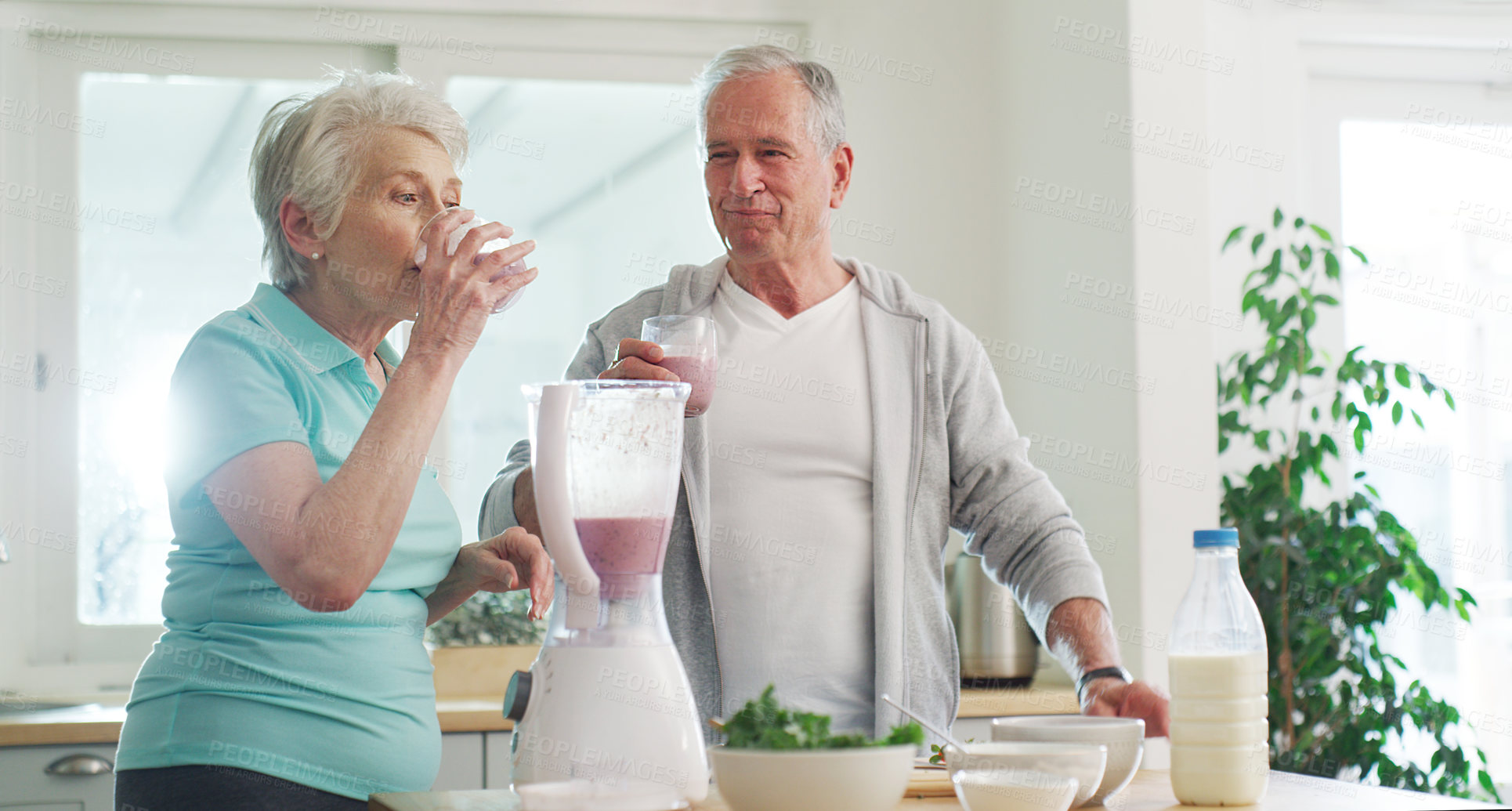 Buy stock photo Cropped shot of a senior couple making a healthy smoothie together at home