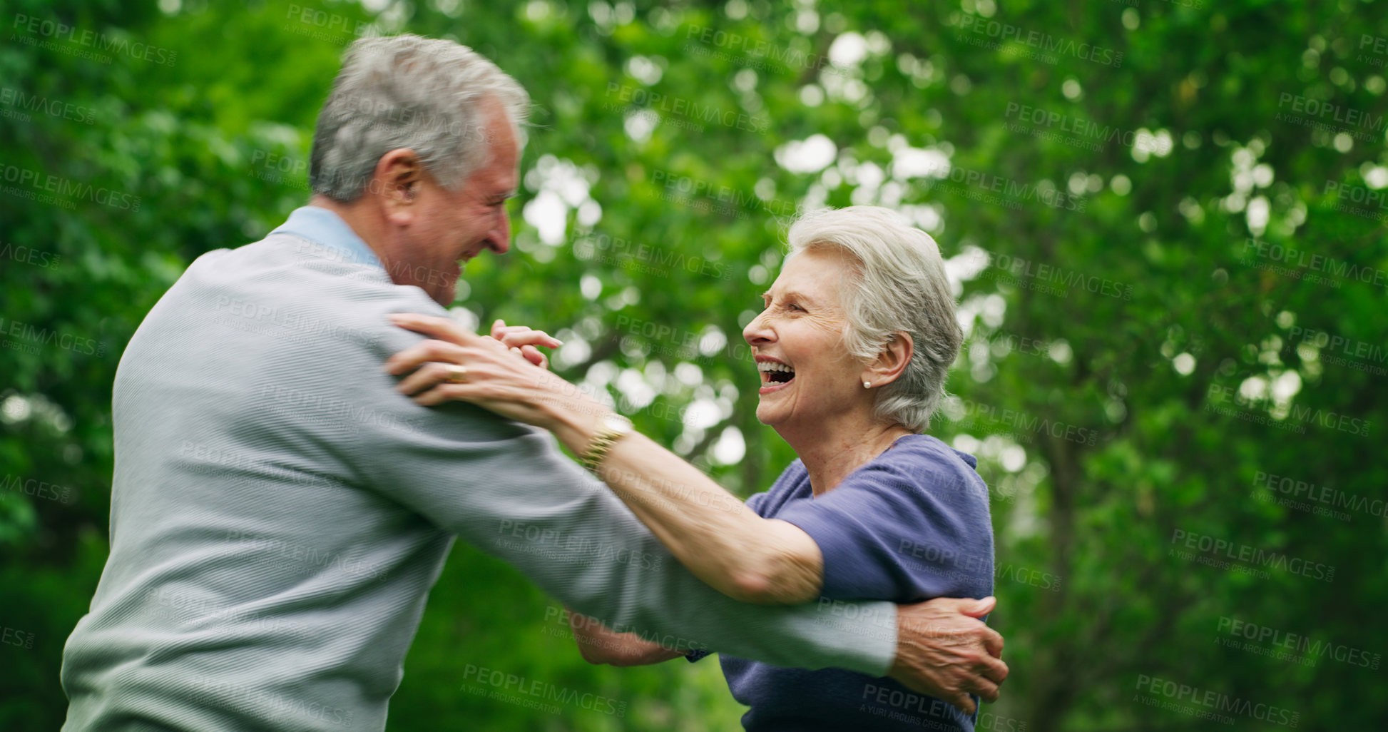 Buy stock photo Shot of a happy senior couple dancing in the park