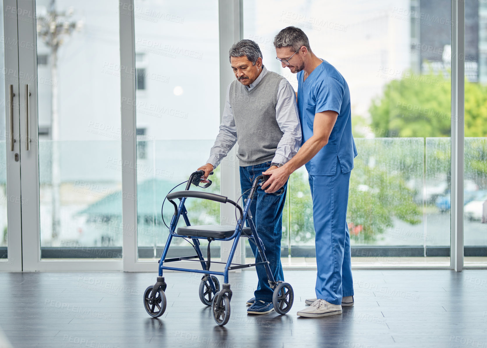 Buy stock photo Shot of a nurse helping a senior man with a walker