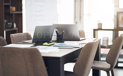 Buy stock photo Still life shot of laptops and paperwork on a table in a modern office