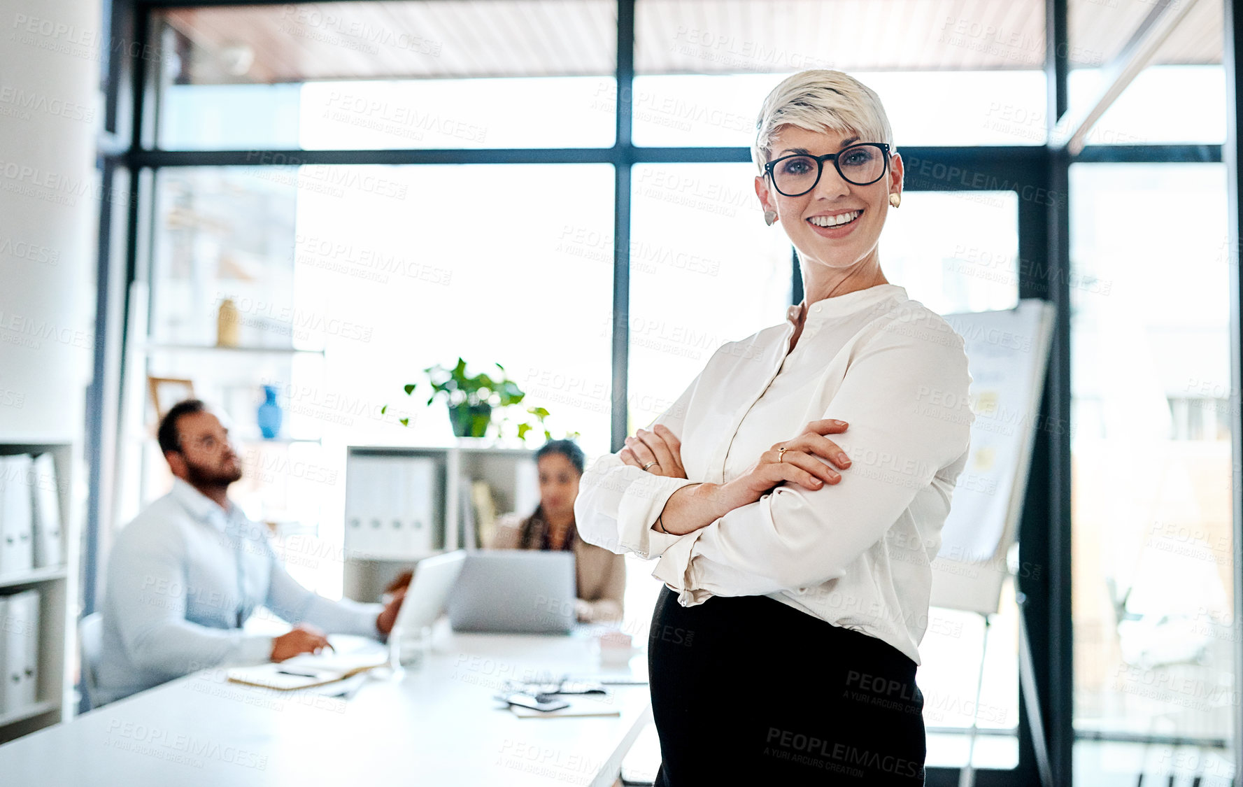 Buy stock photo Portrait of a pregnant businesswoman standing in an office with her colleagues in the background