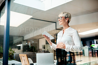 Buy stock photo Shot of a pregnant businesswoman using a digital tablet in an office